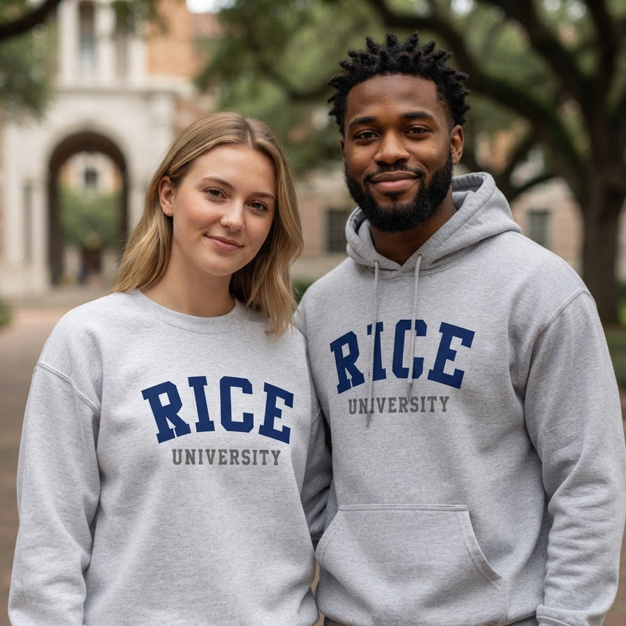 Man and woman wearing gray Rice University hoodie and crewneck sweatshirt with navy blue lettering, standing on a tree-lined college campus