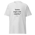 Unisex black t-shirt featuring Justice Empathy quote typography printed across the front chest