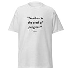 Unisex heather gray t-shirt featuring Freedom Seed Progress quote typography printed across the front chest