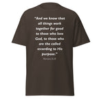 Unisex heather gray t-shirt with Romans 8:28 Bible verse printed in white text on front
