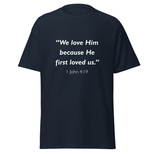 Unisex black t-shirt with 1 John 4:19 Bible verse printed in white text on front