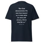 Unisex heather gray t-shirt with Romans 5:8 Bible verse printed in white text on front