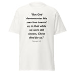 Unisex navy blue t-shirt with Romans 5:8 Bible verse printed in black text on front