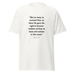 Unisex black t-shirt with John 1:12 Bible verse printed in black text on front