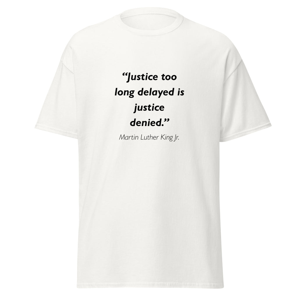 Unisex black t-shirt featuring Martin Luther King MLK Justice Delayed quote typography printed across the front chest