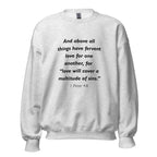 Unisex navy blue sweatshirt with 1 Peter 4:8 Bible verse printed in black text on front