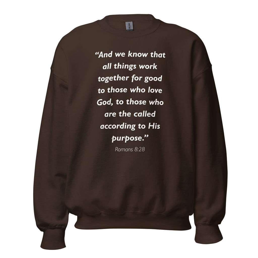 Unisex black sweatshirt with Romans 8:28 Bible verse printed in white text on front