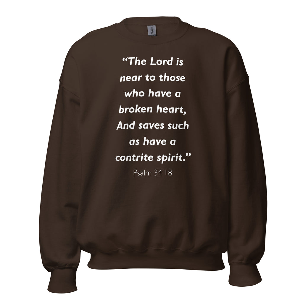 Unisex navy blue sweatshirt with Psalm 34:18 Bible verse printed in white text on front