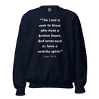Unisex black sweatshirt with Psalm 34:18 Bible verse printed in white text on front