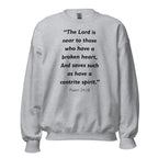 Unisex black sweatshirt with Psalm 34:18 Bible verse printed in black text on front