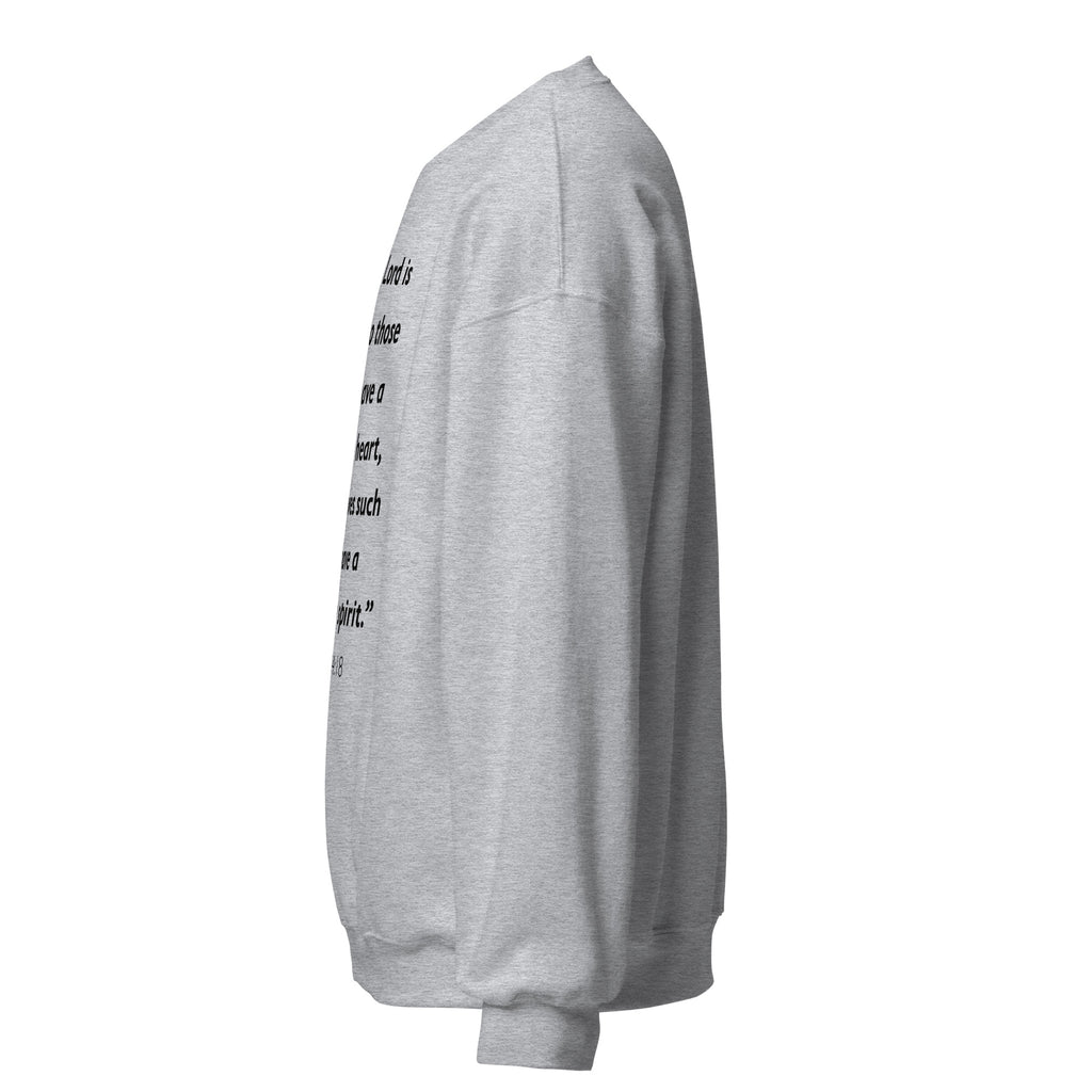 Unisex white sweatshirt with Psalm 34:18 Bible verse printed in black text on front