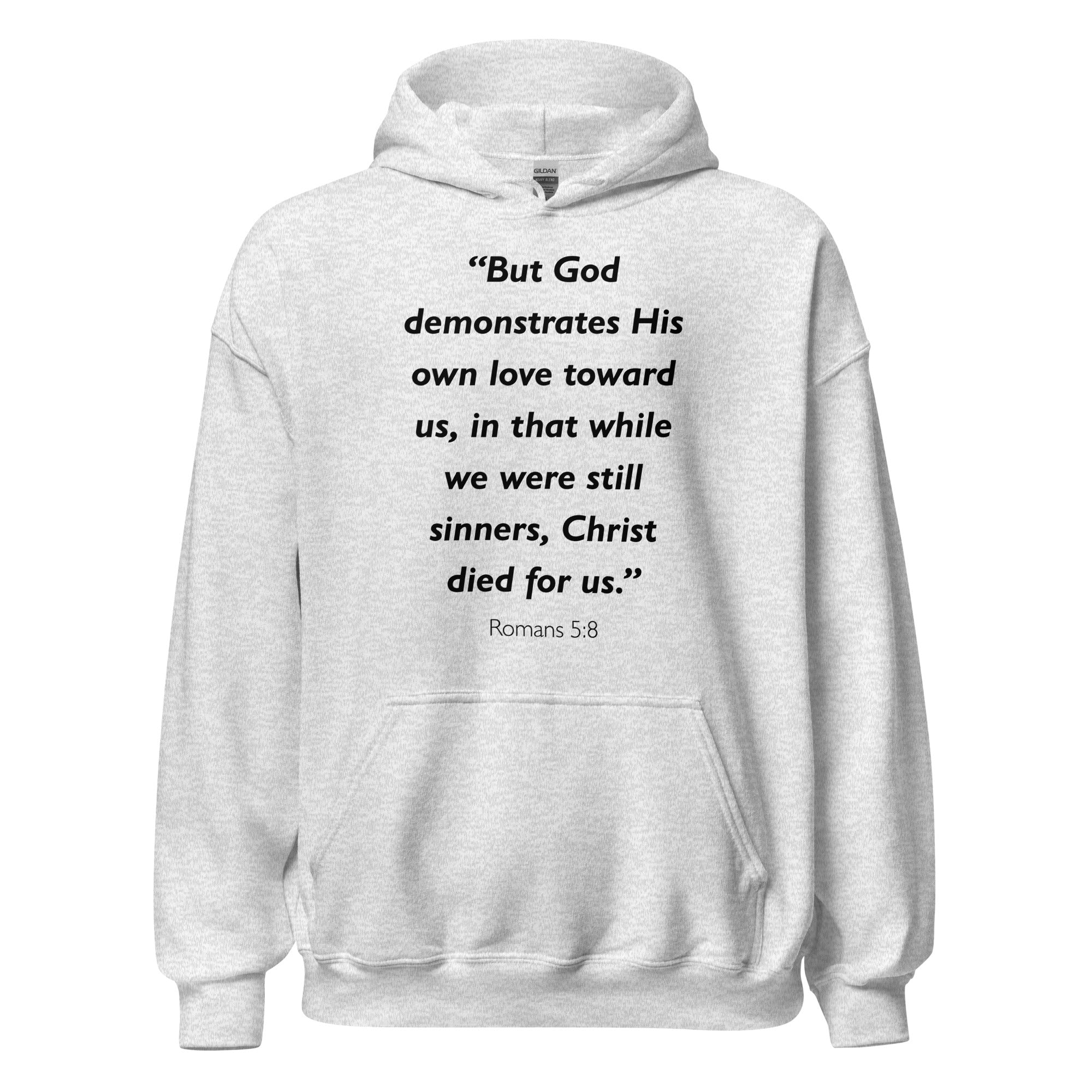 Unisex black hoodie with Romans 5:8 Bible verse printed in black text on front