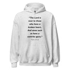Unisex black hoodie with Psalm 34:18 Bible verse printed in black text on front