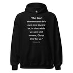 Unisex heather gray hoodie with Romans 5:8 Bible verse printed in white text on front