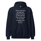 Unisex black hoodie with Romans 8:28 Bible verse printed in white text on front
