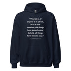 Unisex black hoodie with 2 Corinthians 5:17 Bible verse printed in white text on front