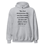 Unisex heather gray hoodie with Romans 5:8 Bible verse printed in black text on front