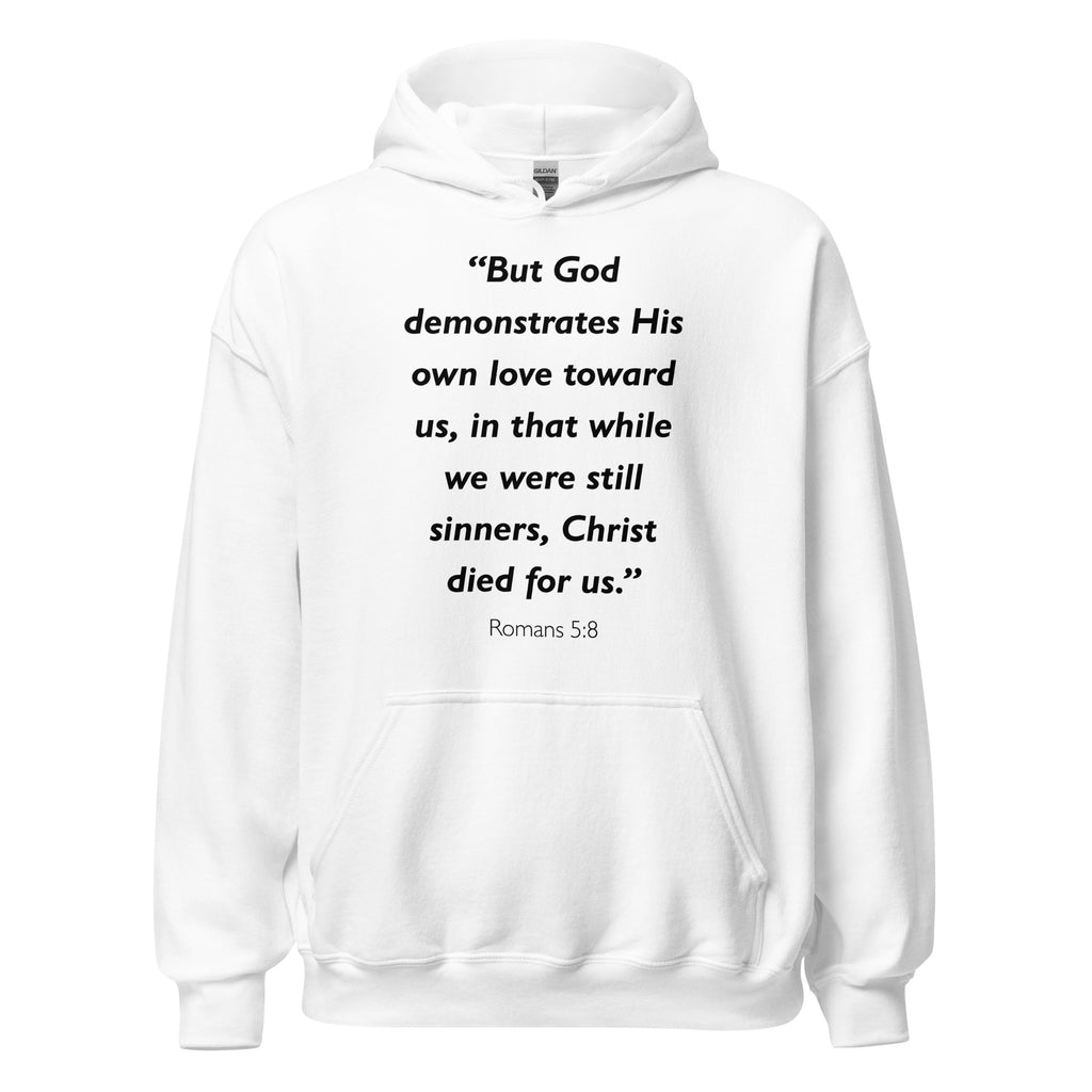 Unisex navy blue hoodie with Romans 5:8 Bible verse printed in black text on front